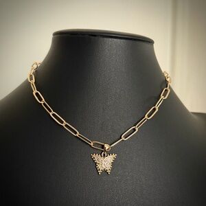 Gold toned paper clip choker with butterfly R charm